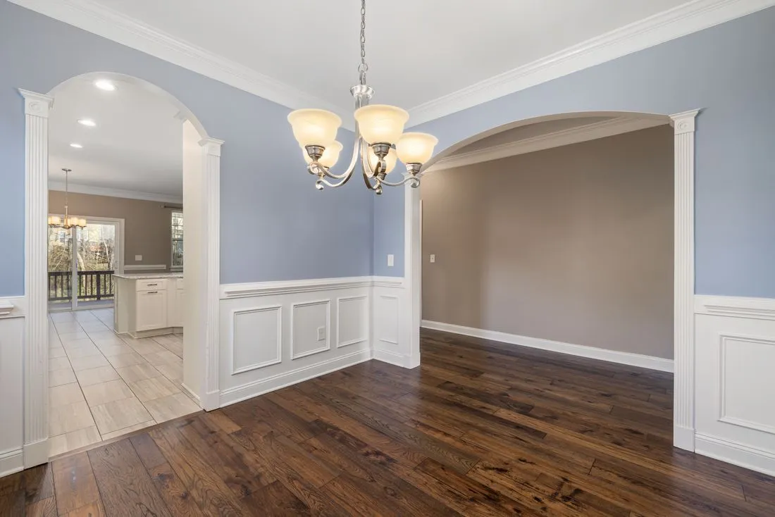 Wide cased opening beside paneled walls