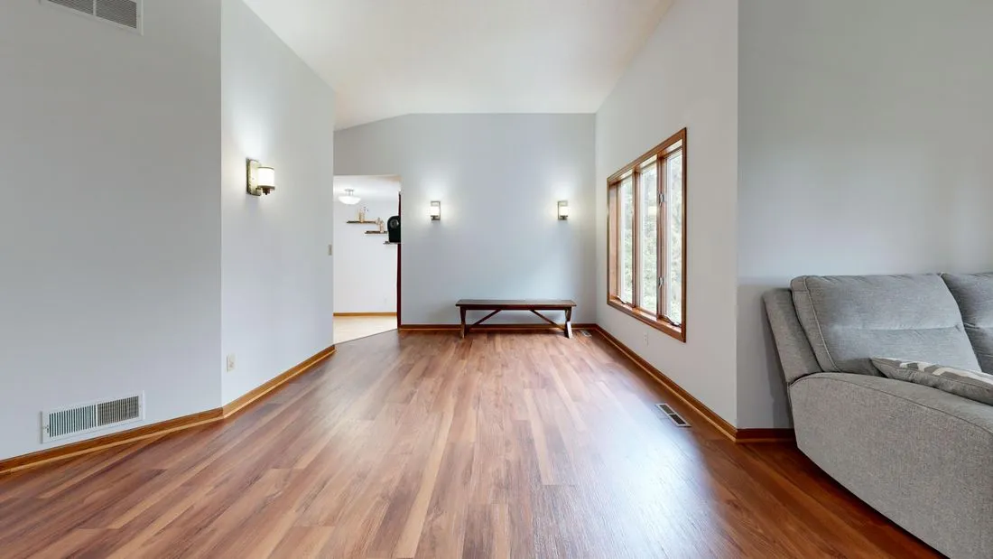 Wood baseboards continuing between adjoining rooms