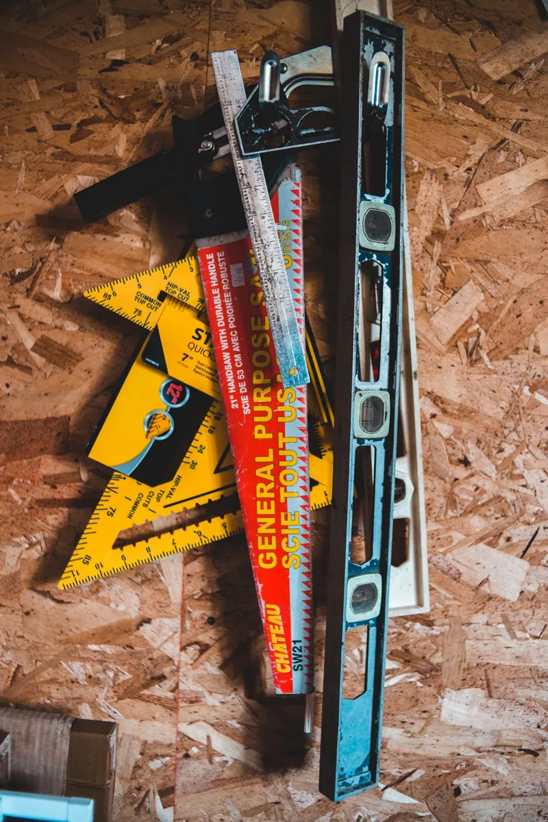 Tape measure, squares and spirit level laid on a workbench