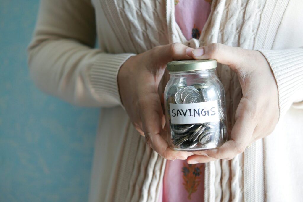 Woman holding a saving jar.